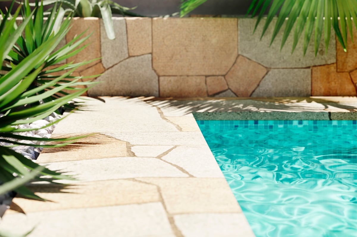 Luxury poolside with natural stone paving
