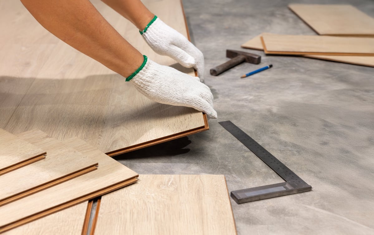 Professional installer laying premium interlocking timber flooring