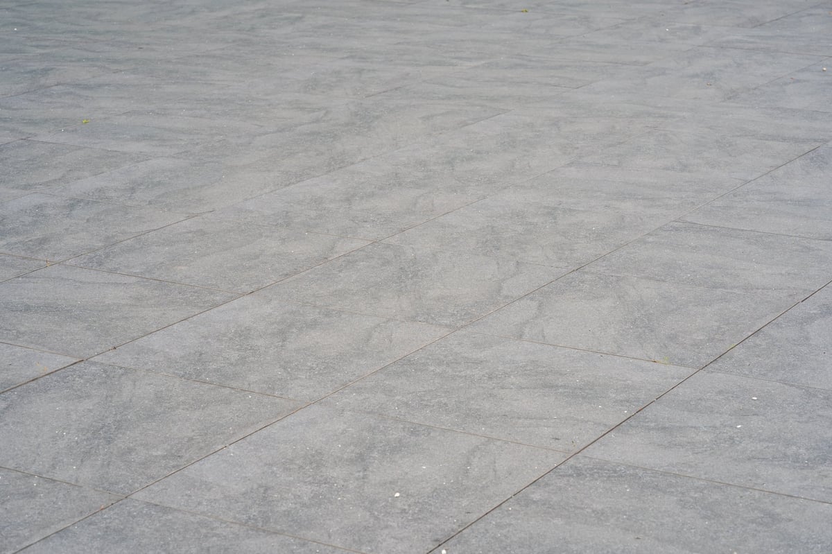 Grey large-format stone pavers in a modern outdoor installation